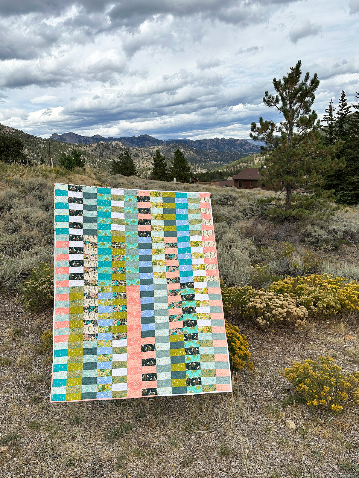Due Pinoli Baseline Quilt as seen in a meadow full of wildflowers near Rocky Mountain National Park in Colorado