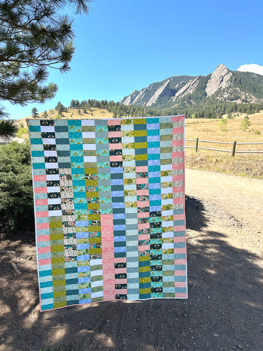 The Due Pinoli Baseline Quilt shown in front of the Flatirons mountains at the top of Baseline Road in Boulder Colorado 